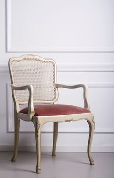 Vintage wooden chair against a white elegant interior wall