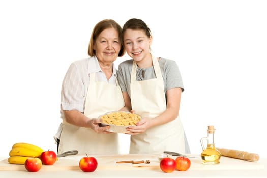 the grandmother and the granddaughter hold beautiful pie in hand