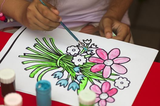 Child painting after a flower contour drawing