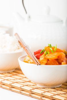 Bowl of sweet and sour chicken photographed closeup.  Useful for menus and other food service applications.