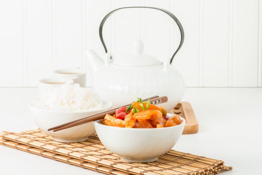 Bowl of sweet and sour chicken and white rice.  Useful for a menu of other food service application.