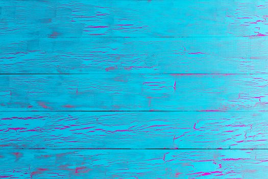 Colorful exotic crackle painted turquoise blue wood background texture in a close up full frame view of the cracked old boards