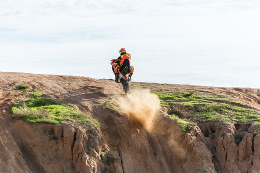 racer on a motorcycle in the desert summer day