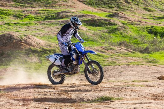 racer on a motorcycle in the desert summer day