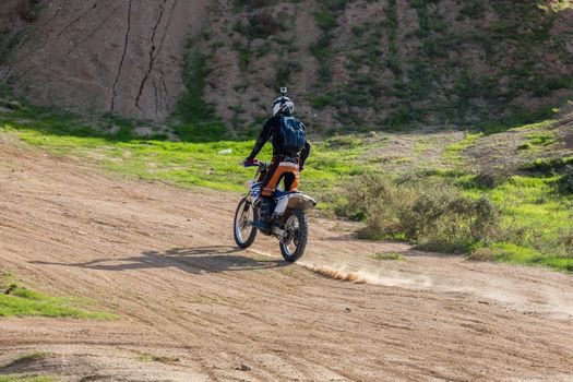 racer on a motorcycle in the desert summer day