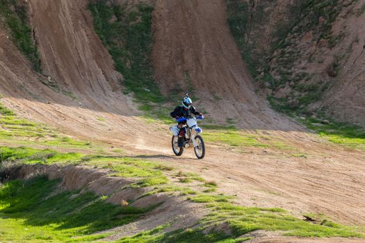 racer on a motorcycle in the desert summer day