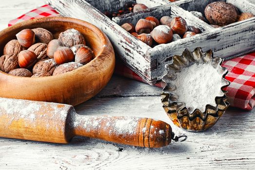 kitchen table with baking dish and a box with walnuts and hazelnuts