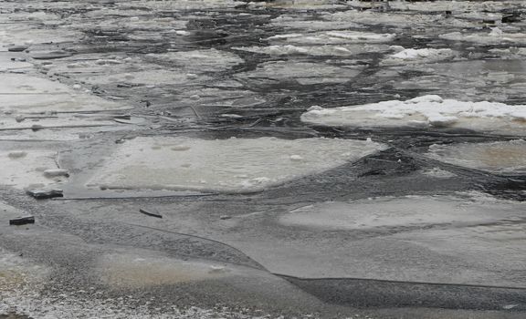 Winter nature background with blocks of ice on frozen water