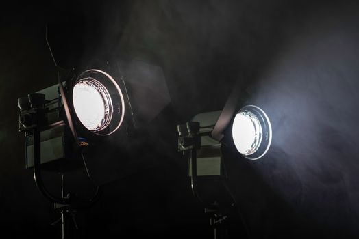 Two studio lights shining through the smoke from smoke machine.