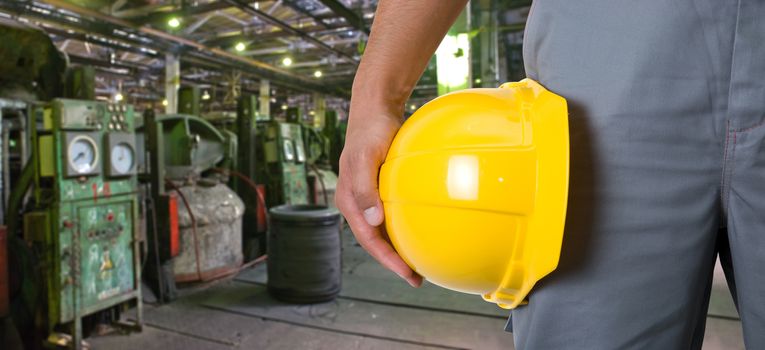 Worker with safety helmet at industrial factory