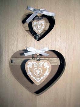 A photo of wooden key box with heart-shaper holes and pendants in them.