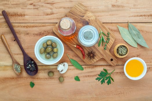 Assortment of herbs rosemary ,thyme,sage, mint,bay leaves , pepper and parsley set up with wooden background concept for international cuisine.