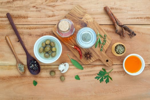 Assortment of herbs rosemary ,thyme,sage, mint,bay leaves , pepper and parsley set up with wooden background concept for international cuisine.