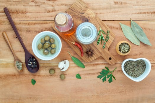 Assortment of herbs rosemary ,thyme,sage, mint,bay leaves , pepper and parsley set up with wooden background concept for international cuisine.