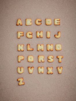 Cookies ABC in the form of alphabet A-Z on brown cardboard background, Valentines day