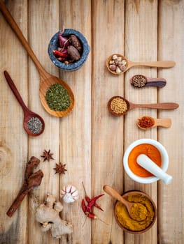 Food Cooking ingredients. Dried Spices herb cinnamon sticks,bay leaves,ginger,turmeric,nutmeg,chili,black pepper,fennel and saffron with the mortar on rustic wooden background.