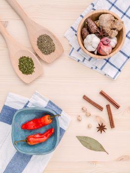 Fresh herbs and spices sage,rosemary,parsley,mint ,holy basil ,nutmeg,star anise ,cinnamon stick,oregano,thyme ,dill and chilli on wooden table. Top view with copy space.