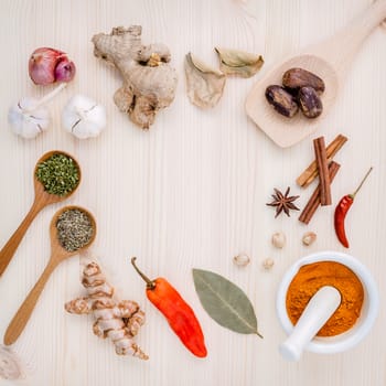 Dried herbs and spices nutmeg,star anise ,cinnamon stick,oregano,thyme ,ginger shallot,turmeric and chili on wooden table. Top view with copy space.