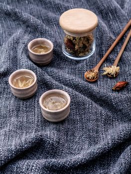 Chrysanthemum tea, Flower tea - Chinese traditional herbal tea made from dried chrysanthemum flower  set up on dark fabric .