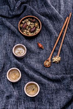 Chrysanthemum tea, Flower tea - Chinese traditional herbal tea made from dried chrysanthemum flower  set up on dark fabric .