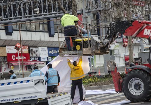 TURKEY, Ankara: Turkish workers erect a white tarpaulin in Guven Park in the Kizilay district, a key transport hub of the Turkish capital city Ankara on March 14, 2016, one day after a car bomb exploded in Ankara  killing at least 32 people and wounding more than 100, according to the health ministry. On February 2016, a bomb attack claimed by a Kurdish militant group on a military convoy in Ankara killed 28 people and wounded dozens more. On October 2015, more than 100 people were killed in a double-suicide bombing at a Kurdish peace rally in Ankara. 