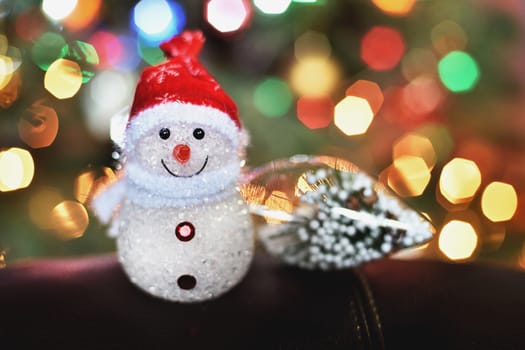 small snowman on blured  lights background