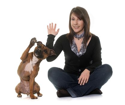 woman and staffordshire bull terrier in front of white background