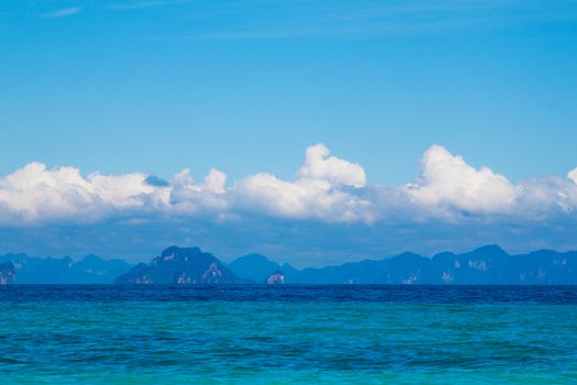  Deep blue Andaman sea view with cloudy sky and rock island on horizon