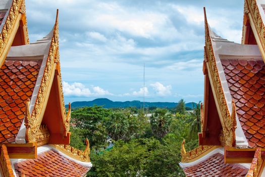 Buddhist asian gold decorated sanctuary on background of cloudy sky