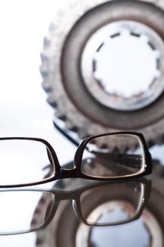 Engineering concept. Spectacles with reflection against gear