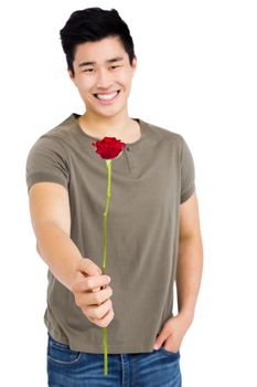 Portrait of happy young man holding bunch of red roses on white background
