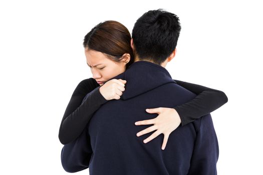 Young couple embracing on white background