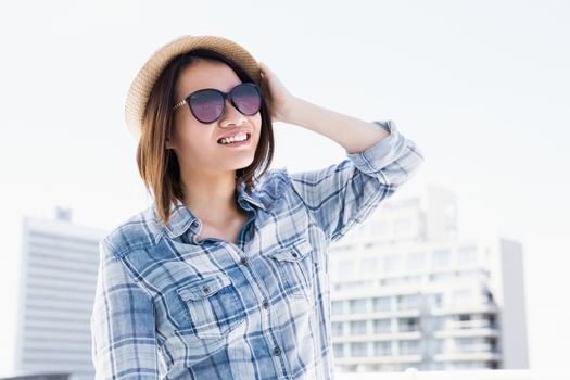 Young woman looking away and smiling outdoors