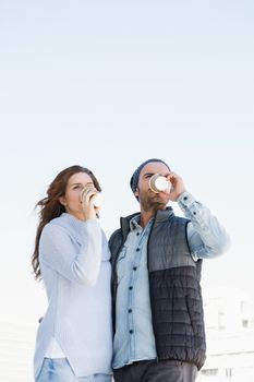 Young couple having coffee together outdoors