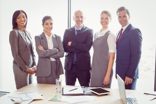Portrait of businesspeople standing together in conference room in office