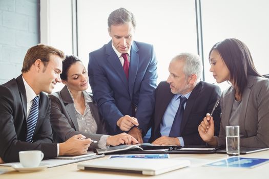 Businesspeople interacting in conference room during meeting