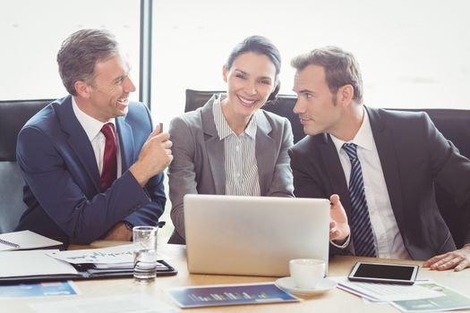 Businesspeople interacting in conference room during meeting