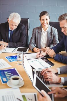 Businesspeople interacting in conference room during meeting