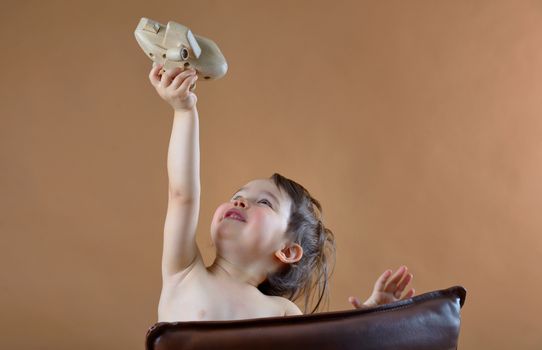  little girl playing with a toy plane in studio