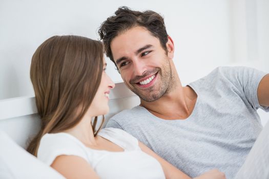 Close-up of romantic couple resting on bed at home