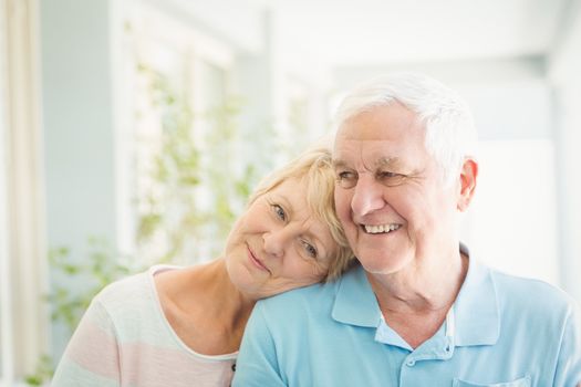 Happy romantic senior couple smiling at home