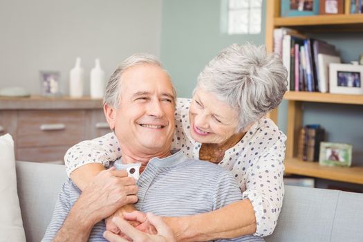 Happy romantic senior couple embracing at home