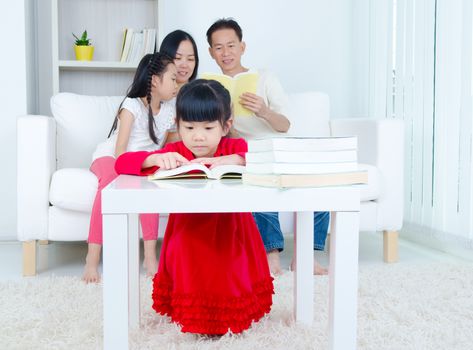 Asian Family reading book at home