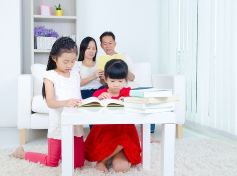 Asian Family reading book at home