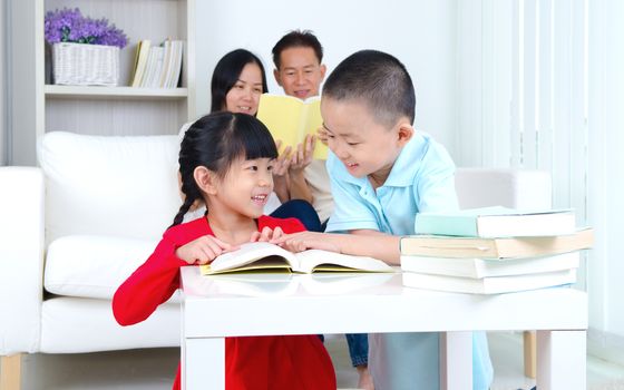 Asian Family reading book at home