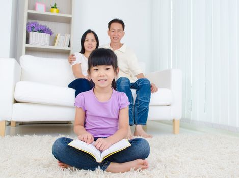 Asian Family reading book at home