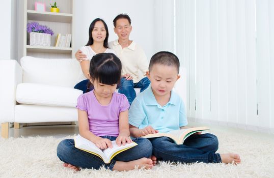 Asian Family reading book at home