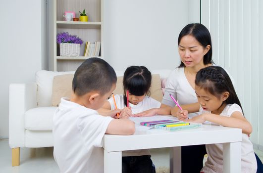 asian family doing school homework at living room