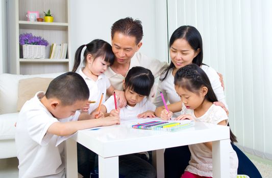 asian family doing school homework at living room