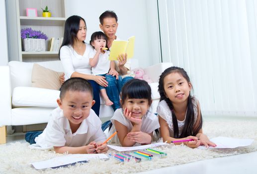 asian family doing school homework at living room